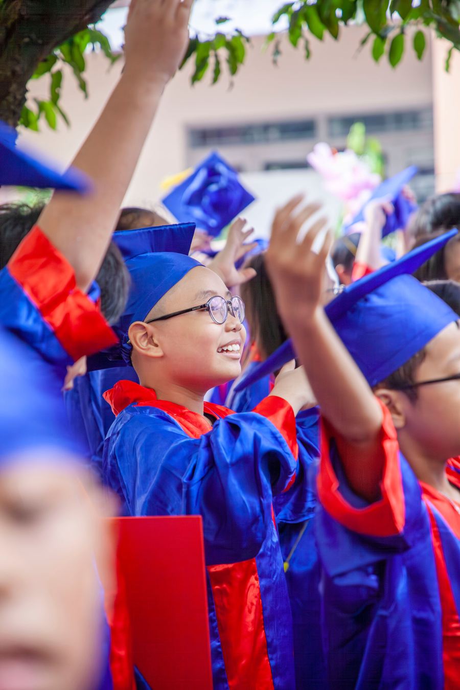 Students celebrating in graduation caps and gowns
